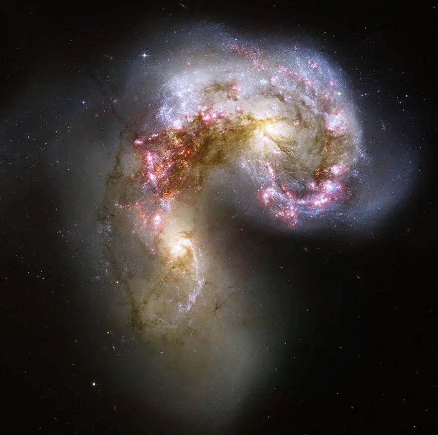 The Antennae galaxies, two spiral galaxies colliding amid bursts of star formation